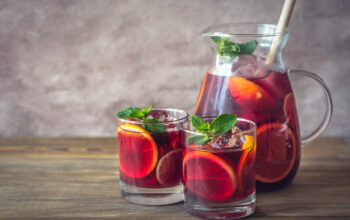 A pitcher and two glasses with Spanish fruit Sangria